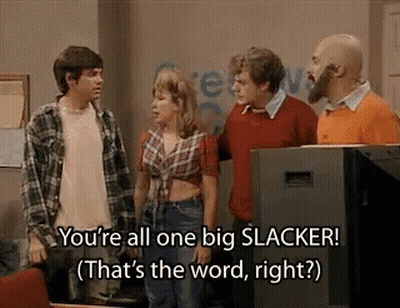 A Group Of People Are Standing Next To Each Other In Front Of A Television And Talking . GIF
