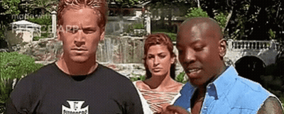 A Group Of People Are Standing Next To Each Other In Front Of A Waterfall . GIF