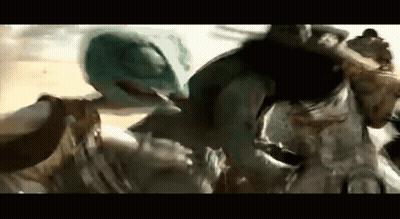 A Group Of People Are Standing Next To Each Other On A Beach . GIF