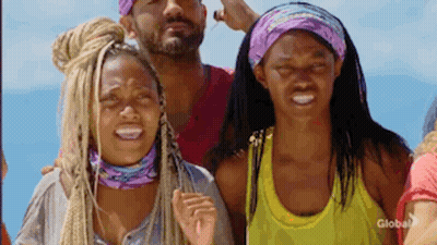 A Group Of People Are Standing Next To Each Other On A Beach And Smiling . GIF
