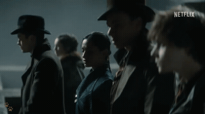 A Group Of People Are Standing Next To Each Other With A Netflix Logo In The Corner GIF