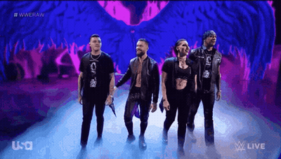 A Group Of People Are Standing On A Stage In Front Of A Purple Background That Says Wwe Raw GIF