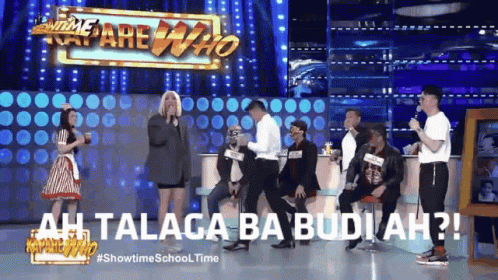A Group Of People Are Standing On A Stage In Front Of A Sign That Says Showbiz School Time GIF