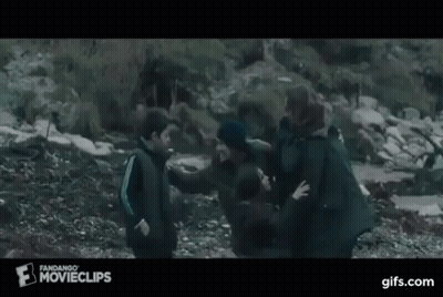 A Group Of People Are Standing On Top Of A Rocky Hill . GIF