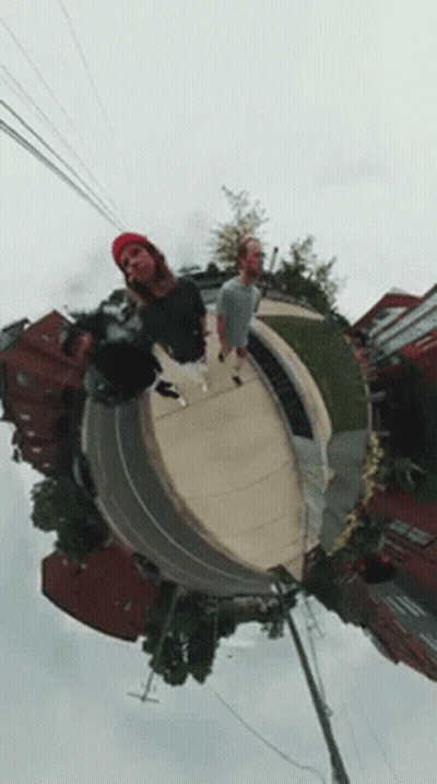 A Group Of People Are Standing On Top Of A Skateboard Ramp . GIF