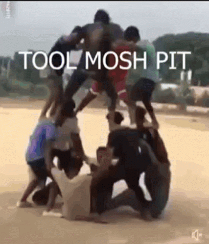 A Group Of People Are Standing On Top Of Each Other In A Pyramid . GIF