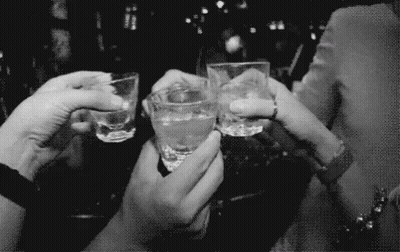 A Group Of People Are Toasting With Shot Glasses In Their Hands GIF