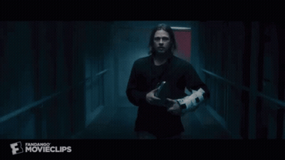 A Group Of People Are Walking Down A Dark Hallway With A Fandango Movieclips Logo On The Bottom GIF