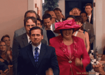 A Group Of People Are Walking Down A Hallway With Box Video Downloader At The Bottom Of The Image GIF