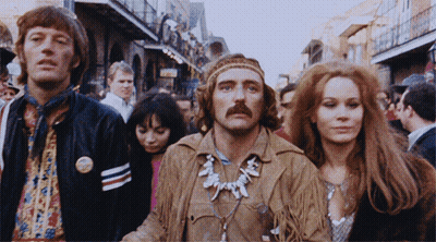 A Group Of People Are Walking Down A Street And One Of Them Has A Button On His Jacket That Says ' Freedom ' On It GIF