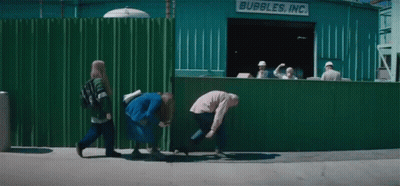 A Group Of People Are Walking In Front Of A Bubbles Inc. Building GIF
