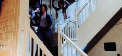 A Group Of People Are Walking Up A Set Of Stairs . GIF
