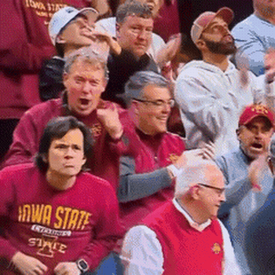 A Group Of People Are Watching A Basketball Game And One Of Them Is Wearing A Iowa State Shirt GIF