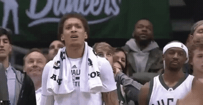 A Group Of People Are Watching A Basketball Game . GIF