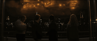 A Group Of People Are Watching Fireworks Over A City At Night GIF