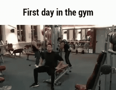 A Group Of People Are Working Out In A Gym . GIF