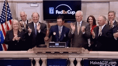 A Group Of People Clapping In Front Of A Screen That Says Fedexcup GIF
