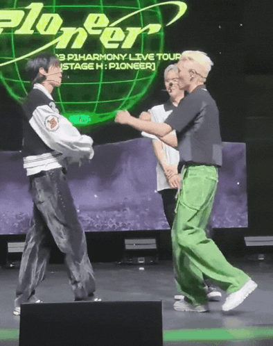A Group Of People Dancing In Front Of A Screen That Says Pioneer GIF