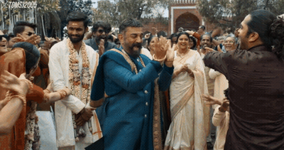 A Group Of People Dancing In Front Of A Sign That Says Toms120905 GIF