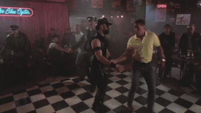 A Group Of People Dancing Under A Neon Sign That Says The Blue Pointer GIF