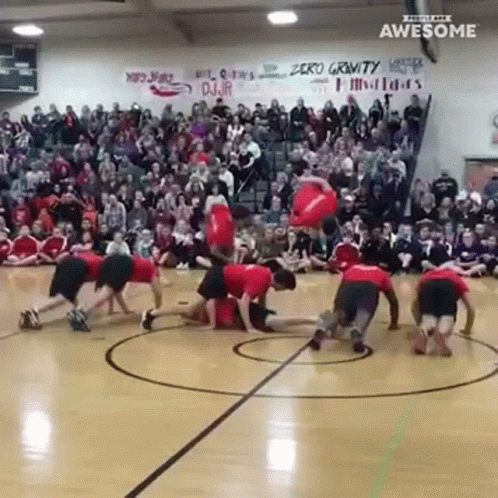 A Group Of People Doing Push Ups On A Basketball Court With A Sign That Says Zero Gravity GIF