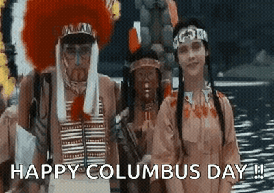A Group Of People Dressed Up As Native Americans Are Standing Next To Each Other In Front Of A Body Of Water . GIF