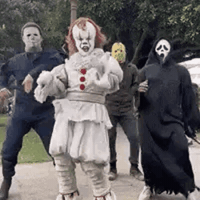 A Group Of People Dressed Up In Halloween Costumes Are Dancing Together . GIF