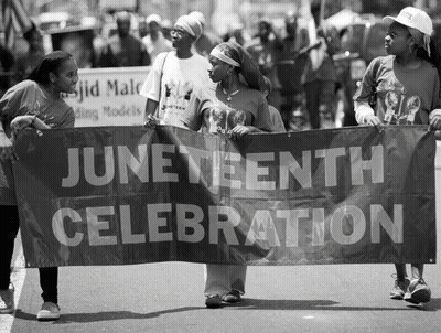 A Group Of People Holding A Banner That Says June Twentieth Celebration GIF