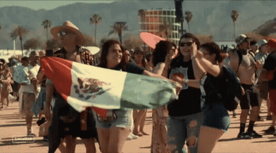 A Group Of People Holding A Mexican Flag In A Crowd At A Music Festival GIF