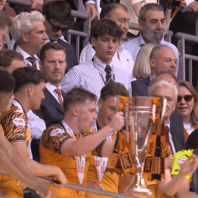 A Group Of People Holding A Trophy With Sky Bet Written On It GIF