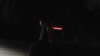 A Group Of People Holding Lightsabers In A Dark Room GIF