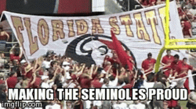 A Group Of People Holding Up A Banner That Says Florida State Making The Seminoles Proud GIF