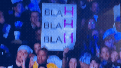 A Group Of People Holding Up A Sign That Says Blah Blah Blah GIF