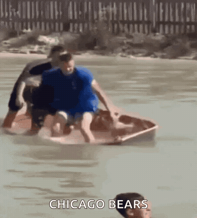 A Group Of People In A Boat In The Water With The Words Chicago Bears On The Bottom . GIF