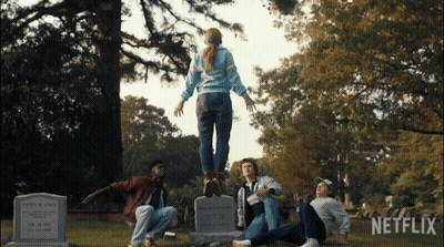 A Group Of People In A Cemetery With Netflix Written On The Bottom GIF
