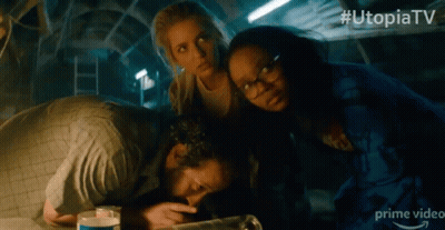 A Group Of People In A Dark Room With # Utopiatv On The Bottom Right GIF