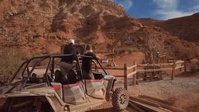A Group Of People In A Polaris Atv In The Desert GIF