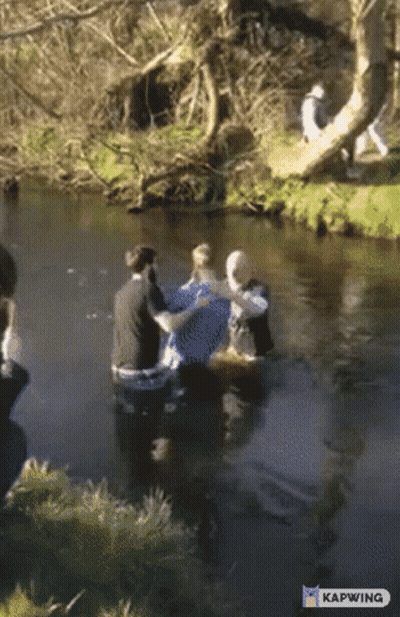 A Group Of People In A River With Kapwing Written On The Bottom Right GIF