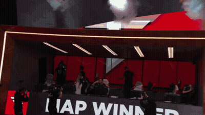 A Group Of People In A Room With A Sign That Says I Ap Winner GIF