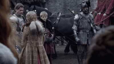A Group Of People In Armor Are Standing Next To A Horse Drawn Carriage GIF