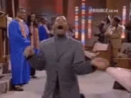 A Group Of People In Blue Robes Are Standing In A Room With A Blurred Background . GIF