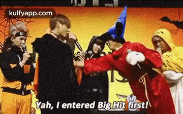 A Group Of People In Costumes Are Standing Next To Each Other And Talking . GIF