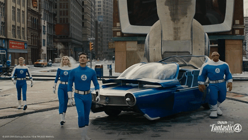 A Group Of People In Fantastic 4 Costumes Are Walking Down A Street GIF