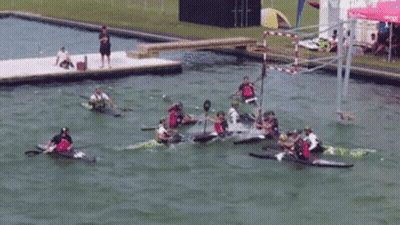 A Group Of People In Kayaks Are Racing In A Lake GIF