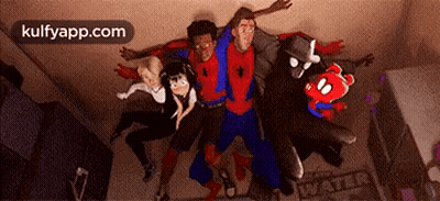 A Group Of People In Spiderman Costumes Are Standing Next To Each Other . GIF