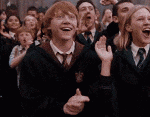 A Group Of People In Suits And Ties Are Laughing GIF