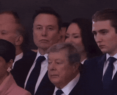 A Group Of People In Suits And Ties Are Sitting Together GIF