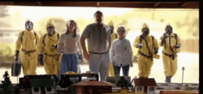 A Group Of People In Yellow Suits And Gas Masks Are Standing Next To Each Other . GIF