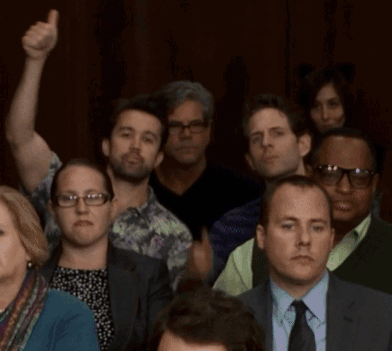 A Group Of People Including A Man In A Suit And Tie Giving A Thumbs Up GIF