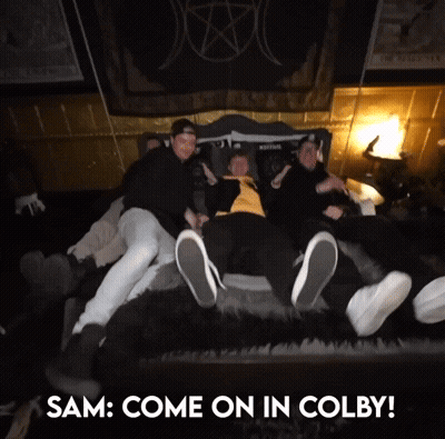 A Group Of People Laying On A Bed With The Words " Sam Come On In Colby " GIF